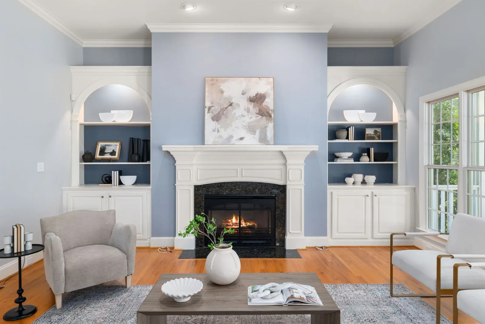Stylish living room with a modern fireplace, elegant decor, and cozy seating.